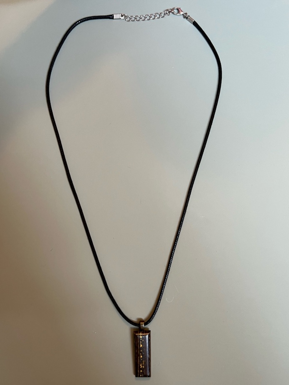 Sleek Black Cord Necklace with Rectangular Metallic Pendant